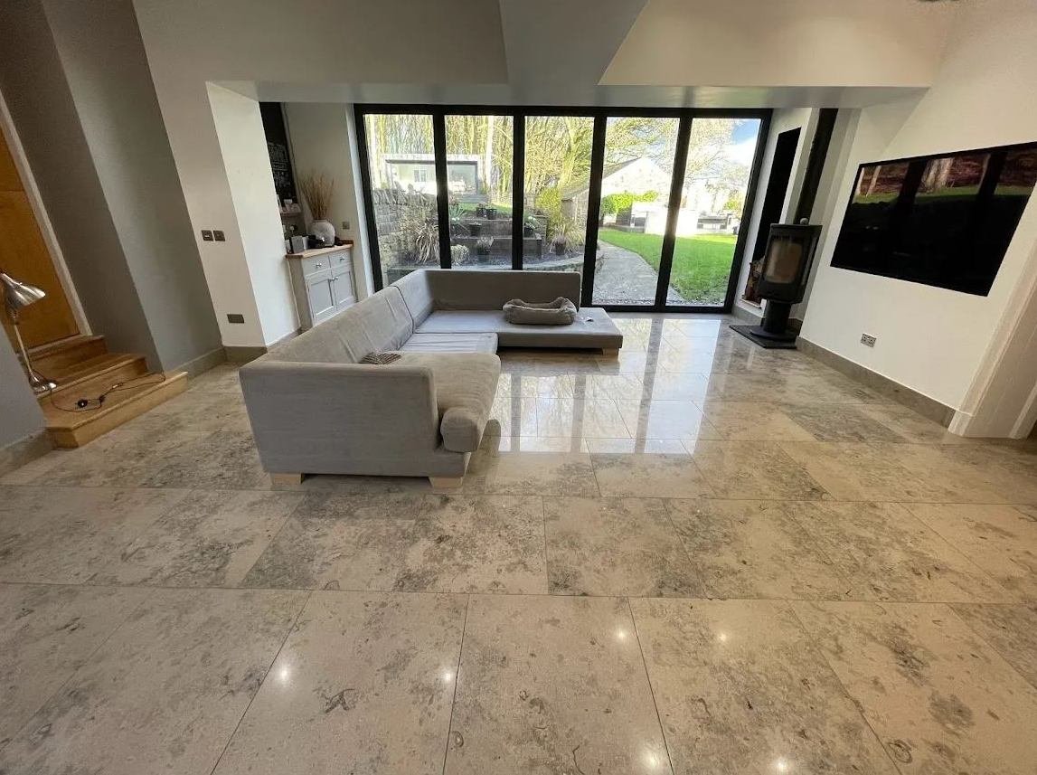 Polished limestone floor in an open-plan living space